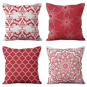 Detailed close-up of four red and white geometric printed decorative throw pillow covers
