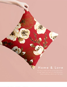Close-up of red Chinese floral throw pillow showing fabric texture and zipper detail