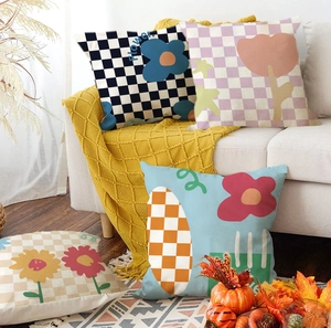 Set of four floral checkerboard pillow covers on a white sofa in a cozy interior