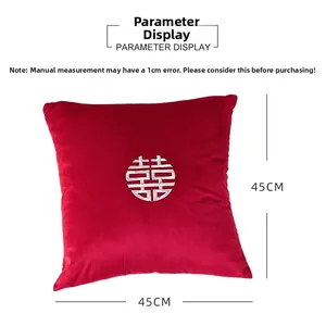 Gros plan d'un coussin de mariage en velours rouge 45x45cm avec broderie du signe Xi