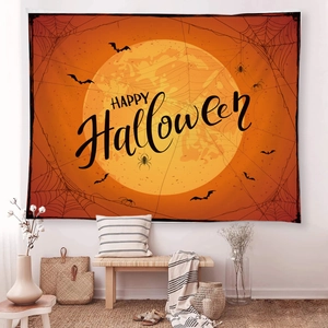 Detail of Halloween tapestry with orange full moon and black bats on a white wall