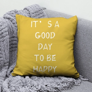 Detail of yellow peach skin fabric pillow with happy slogan on grey sofa background