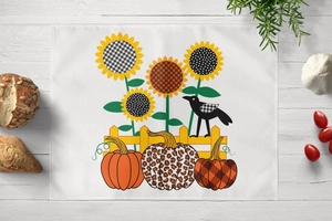 Detail of harvest table mat featuring sunflowers and pumpkins on white wood background
