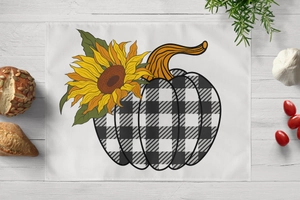 Close-up of harvest placemat with sunflower pumpkin print on white wood table