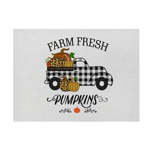 Linen placemat with buffalo plaid truck and assorted pumpkins for Thanksgiving harvest decor
