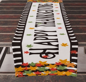 Detail of Happy Thanksgiving table runner featuring autumn maple leaves and stripes