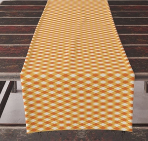 Close-up of orange checkered table runner on vintage wood for autumn holiday decor