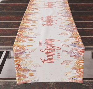 Detail of Happy Thanksgiving Day table runner with autumn pumpkin and maple leaf patterns