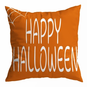 Detail of a bright orange peach skin pillowcase with a white Happy Halloween spiderweb print
