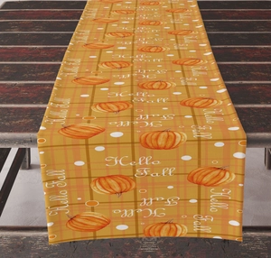 Detail of Hello Fall table runner featuring orange pumpkin prints and rustic wood texture