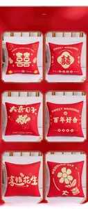 Detail showing set of six red Chinese wedding cushions with festive patterns and icons