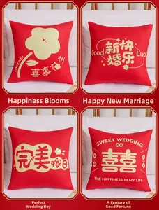 Detail view of four Chinese wedding red throw pillows with golden festive embroidery patterns