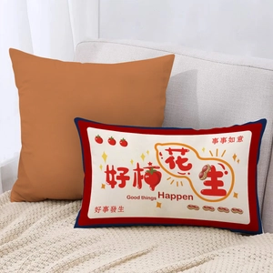 Close-up of lumbar pillow with Chinese New Year motifs of persimmons and peanuts