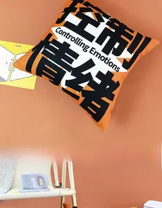 Detail of orange cushion cover featuring Controlling Emotions print on a white chair