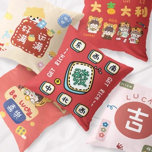 Detail view of red Chinese New Year cushion covers with cute cartoon prints and auspicious text