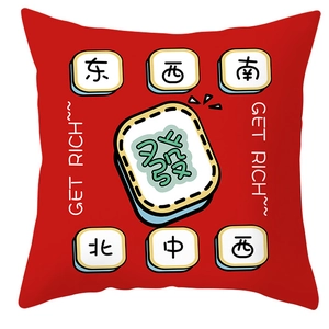 Detail view of red festive pillowcase with Chinese mahjong motifs and Get Rich text