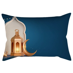 Macro view of blue lumbar pillow with gold moon and lantern print for Ramadan decor