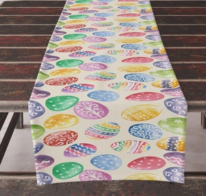 Detailed view of Easter table runner with colorful egg patterns on rustic wood table