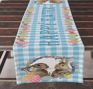 Detail of blue gingham Easter table runner with bunny, floral wreath and Happy Easter text
