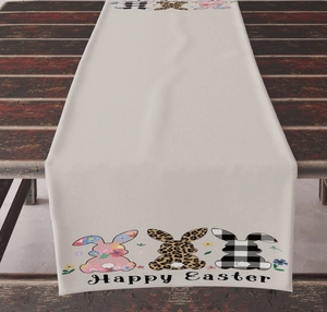 Close-up of Happy Easter table runner with floral and leopard print rabbits on wood