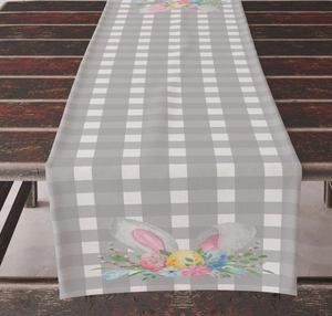 Close-up of Easter table runner with bunny ears and floral eggs on rustic wood
