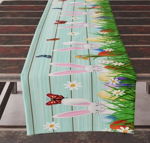 Detail showing Easter table runner with bunny and egg prints on light blue wood texture