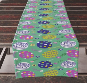 Detail of Easter table runner with colorful egg patterns on a brown wooden surface