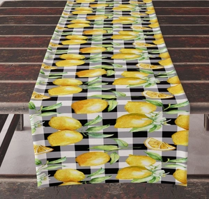 Detailed view of linen table runner with yellow lemons on black and white gingham