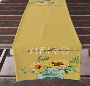 Detail of sunflower and succulent print on yellow linen table runner with HELLO sunshine text