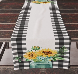 Detailed texture of sunflower and lemon print table runner with buffalo plaid border