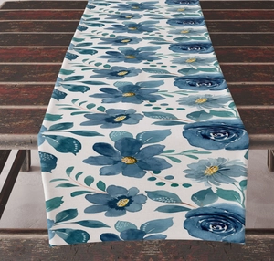 Close-up of blue floral print linen table runner on vintage brown wooden surface