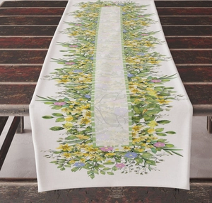 Detailed texture of floral linen table runner with daisy pattern on a vintage wooden table