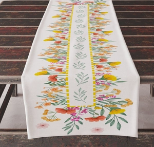 Close-up of floral print table runner on dark wood, showing linen texture and vibrant petals