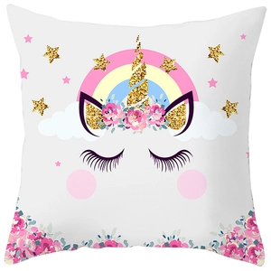 Detail of cute unicorn print on peach skin pillowcase with rainbow and flower patterns