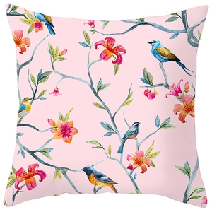 Detail of peach skin pillowcase with watercolor floral and bird prints on pink background