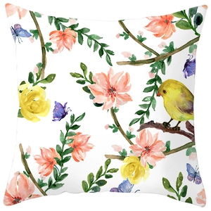 Close-up of floral pillowcase featuring watercolor birds, blossoms, and peach skin texture
