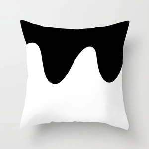 Detail shot of square cushion cover featuring minimalist black and white fluid wave pattern