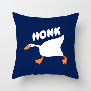 Detailed close-up of a blue throw pillow featuring a white goose and HONK text