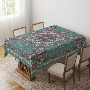 Close-up of bohemian turquoise tablecloth with intricate mandala patterns on a wooden table