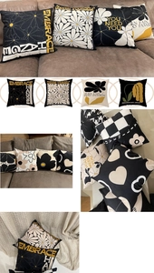 Close-up of black and white floral pillow covers with abstract daisy and checkered patterns