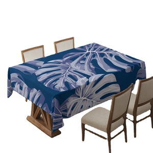 Bohemian blue tablecloth featuring large purple monstera leaf prints for dining room tables