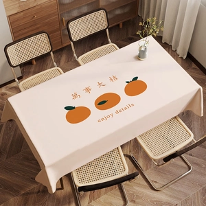 Detail of warm beige velvet tablecloth featuring orange persimmons and artistic calligraphy