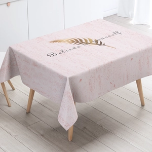 Detail of pink marble texture tablecloth with golden leaf and 'Believe in yourself' text