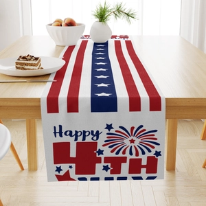 Linen table runner with Happy 4th of July patterns on a wooden dining table
