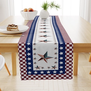 Detail of Independence Day linen table runner with stars and stripes on a wooden table