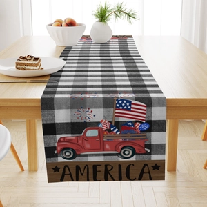 Detail of linen table runner featuring black buffalo plaid and vintage red American truck