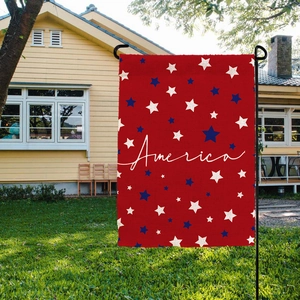 Detail of red America garden flag with stars and black metal stand on lawn
