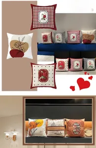 Detail of red houndstooth and floral pattern cushion covers on a blue fabric sofa
