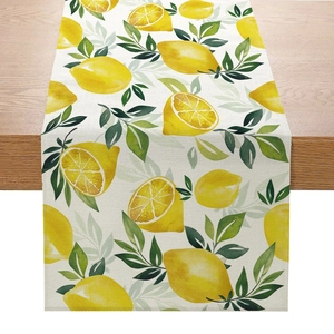 Detail of linen table runner with watercolor lemon and green leaf summer floral print