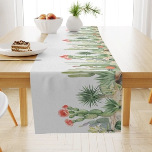 Macro detail of high-quality linen table runner with green cactus and pink flower prints